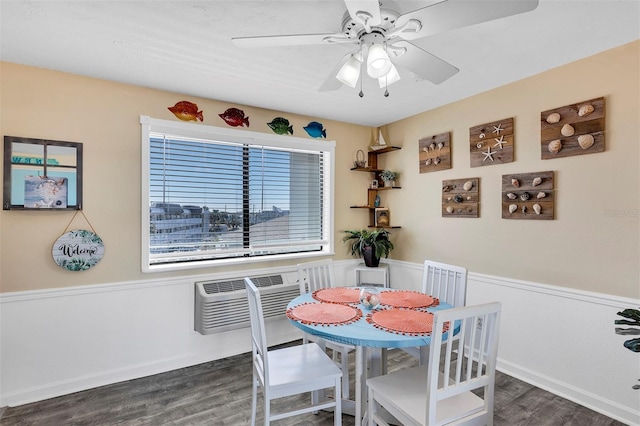 dining area featuring ceiling fan, a wall mounted air conditioner, and dark hardwood / wood-style floors