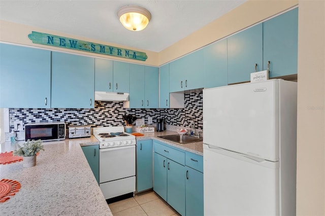 kitchen featuring tasteful backsplash, white appliances, sink, blue cabinetry, and light tile patterned floors