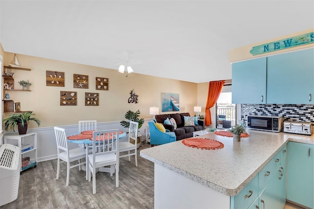 kitchen with decorative backsplash, hardwood / wood-style floors, and ceiling fan