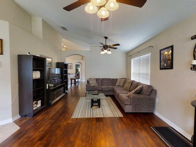 living room featuring ceiling fan and dark hardwood / wood-style flooring