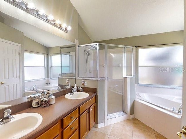 bathroom featuring tile patterned floors, vanity, plus walk in shower, and vaulted ceiling