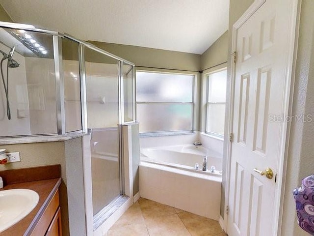 bathroom with tile patterned flooring, vanity, and shower with separate bathtub