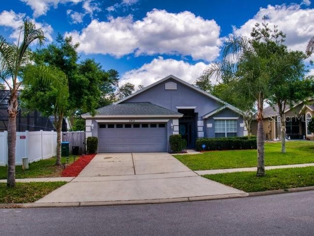 view of front of house with a front yard and a garage