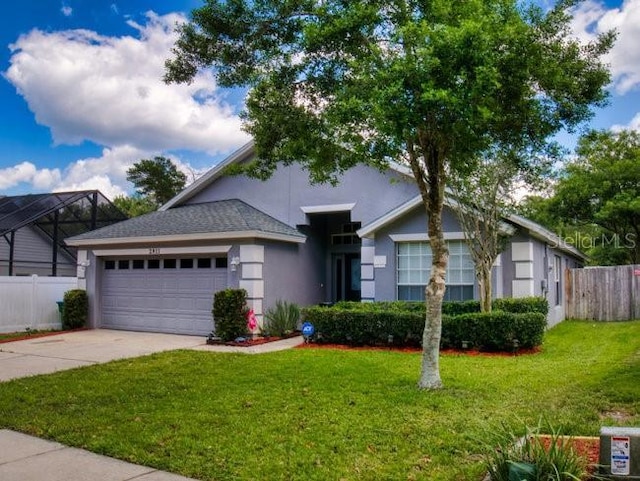 view of front of home with a garage and a front lawn