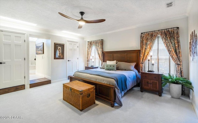 carpeted bedroom with ceiling fan, ensuite bathroom, a textured ceiling, and ornamental molding