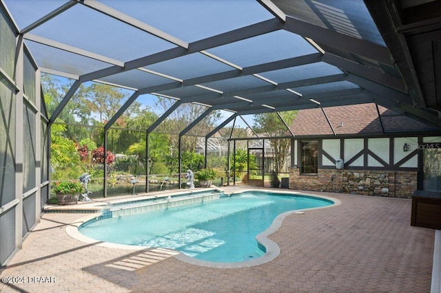 view of pool with a lanai and a patio area