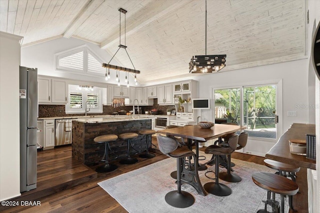 dining space featuring dark hardwood / wood-style flooring, wood ceiling, sink, high vaulted ceiling, and beamed ceiling