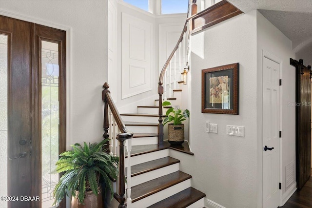 stairs with a textured ceiling