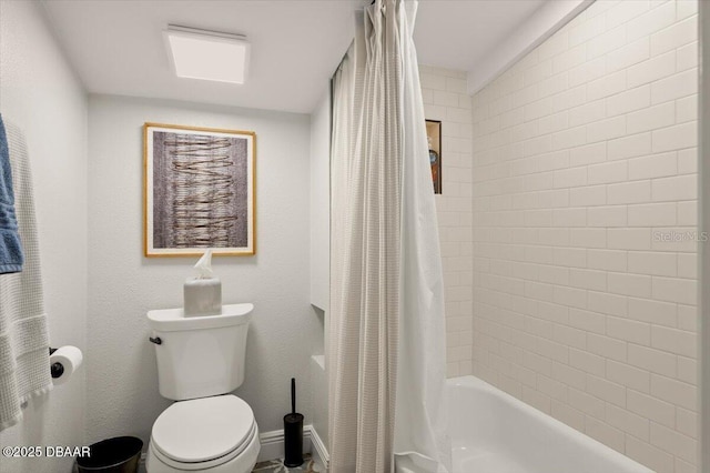 bathroom with shower / bath combo and toilet