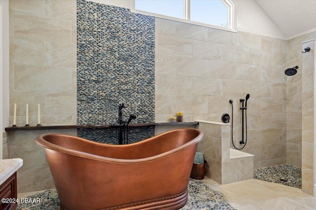 bathroom featuring vanity, vaulted ceiling, tile walls, and independent shower and bath