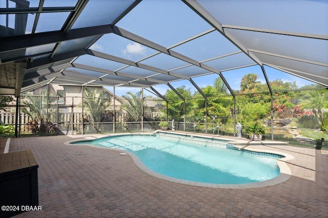 view of swimming pool featuring a patio and glass enclosure