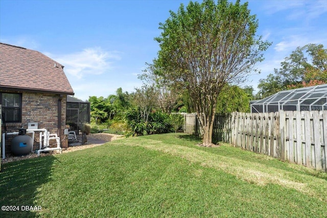 view of yard featuring glass enclosure