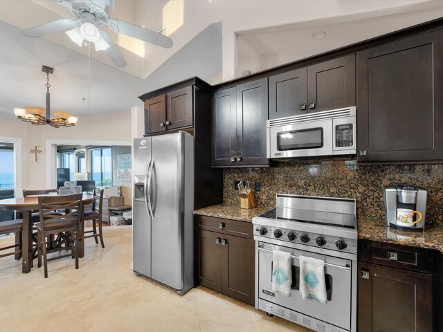 kitchen featuring stone countertops, decorative backsplash, a notable chandelier, dark brown cabinetry, and stainless steel appliances