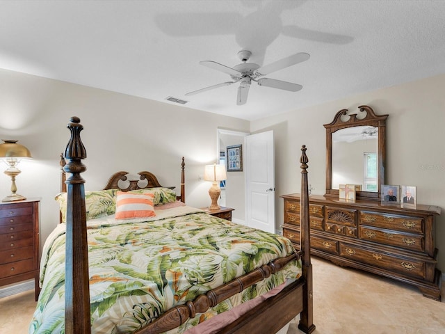 bedroom with a textured ceiling and ceiling fan