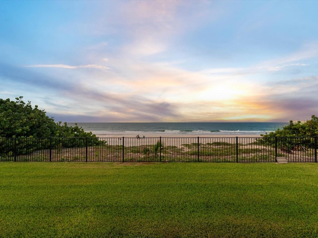 yard at dusk featuring a water view