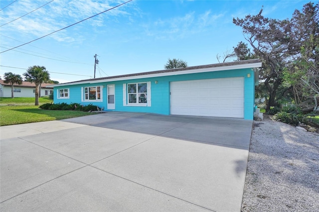 ranch-style home featuring a garage and a front lawn