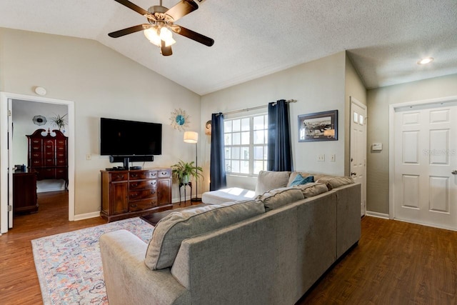 living room with a textured ceiling, ceiling fan, hardwood / wood-style floors, and lofted ceiling