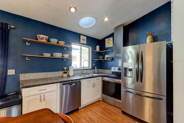 kitchen featuring white cabinetry, light hardwood / wood-style flooring, stainless steel appliances, and sink