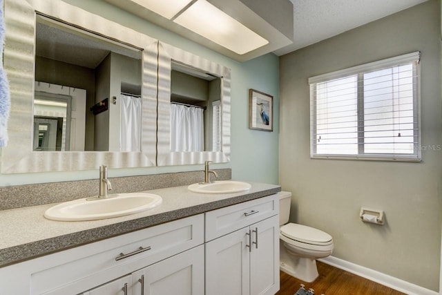 bathroom featuring hardwood / wood-style floors, vanity, and toilet