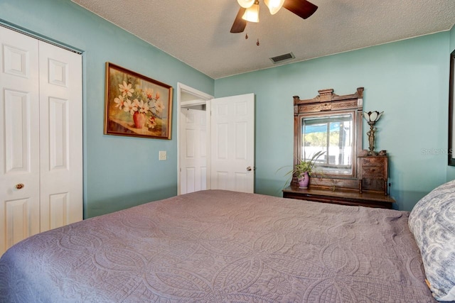 bedroom featuring a textured ceiling, a closet, and ceiling fan