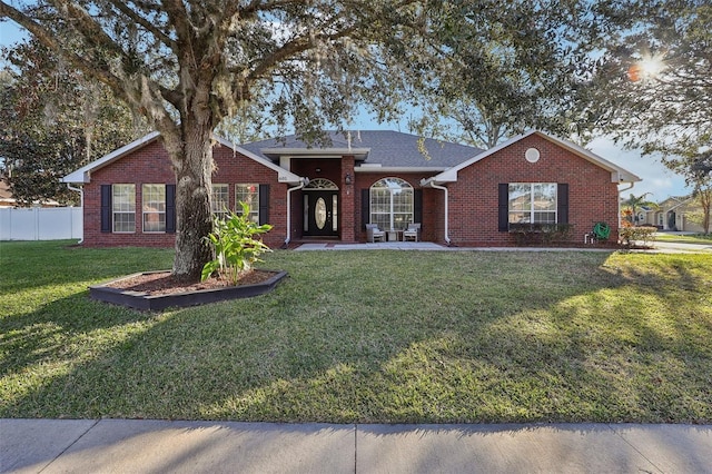 ranch-style home with a front lawn