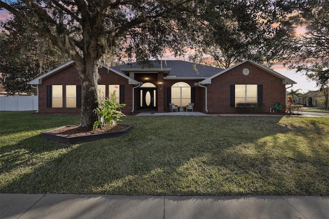 view of front of house with a yard