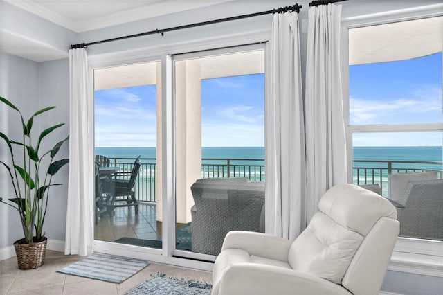 doorway featuring light tile patterned flooring, a water view, and crown molding