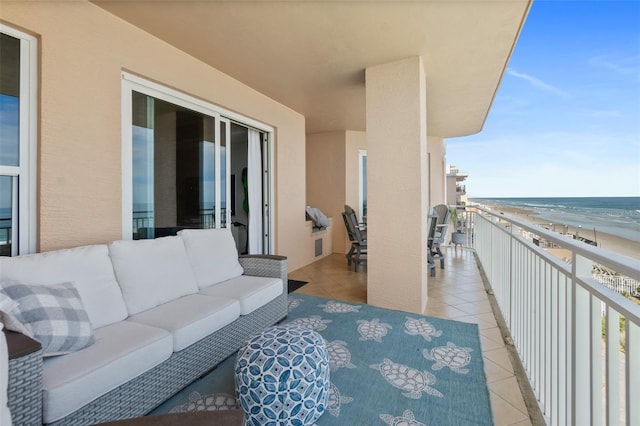 balcony featuring a water view and an outdoor hangout area