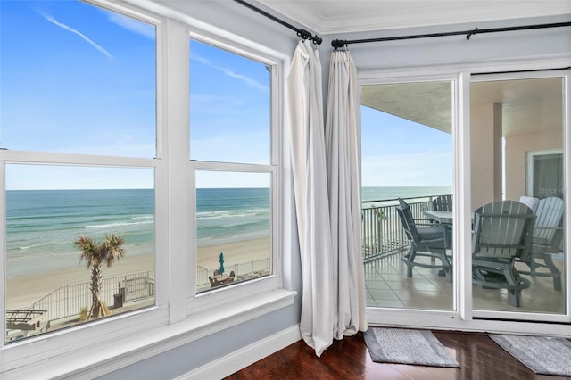 sunroom / solarium with a water view and a view of the beach