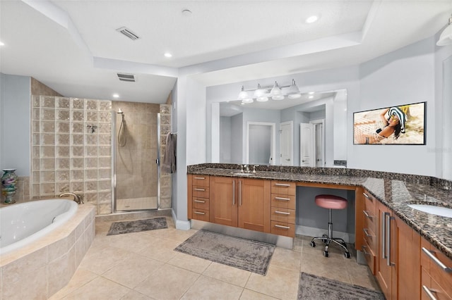 bathroom with tile patterned flooring, vanity, and shower with separate bathtub