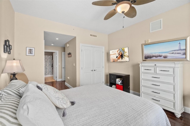 bedroom with a closet, ceiling fan, and dark hardwood / wood-style floors