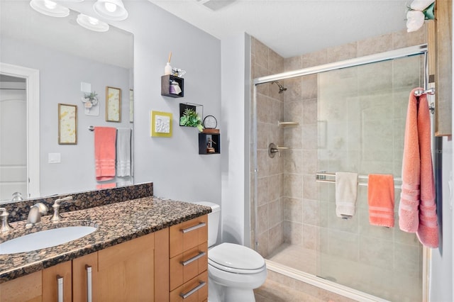 bathroom featuring vanity, toilet, and walk in shower