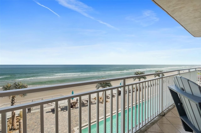 balcony featuring a water view and a view of the beach