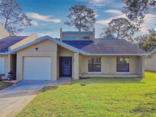 view of front of house with a front yard and a garage