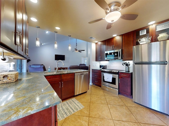 kitchen with decorative light fixtures, sink, appliances with stainless steel finishes, light tile patterned flooring, and decorative backsplash