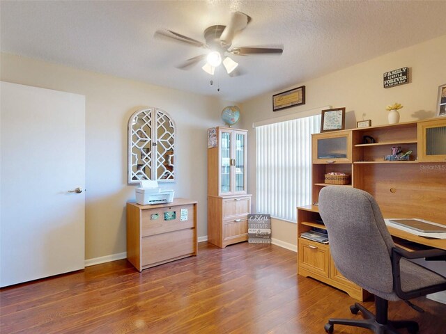 office area with hardwood / wood-style flooring, ceiling fan, and a textured ceiling