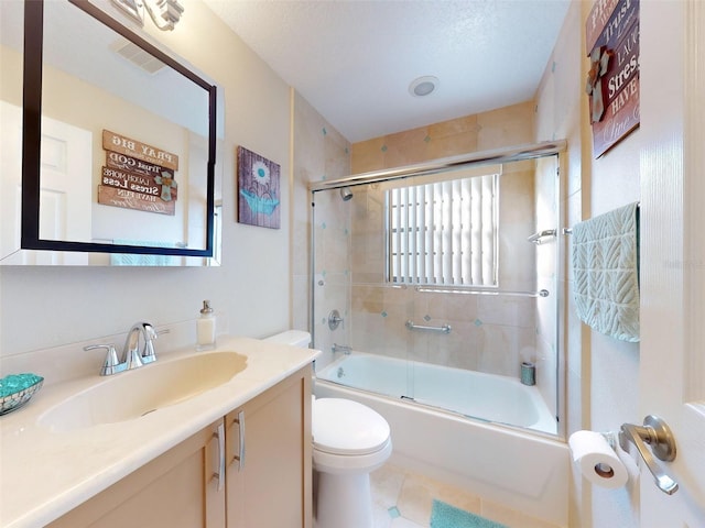 full bathroom featuring toilet, a textured ceiling, vanity, and enclosed tub / shower combo