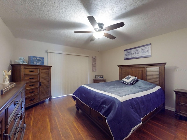 bedroom with ceiling fan, a closet, dark wood-type flooring, and a textured ceiling