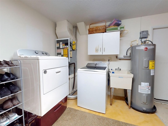 clothes washing area with washing machine and dryer, cabinets, electric water heater, sink, and a textured ceiling