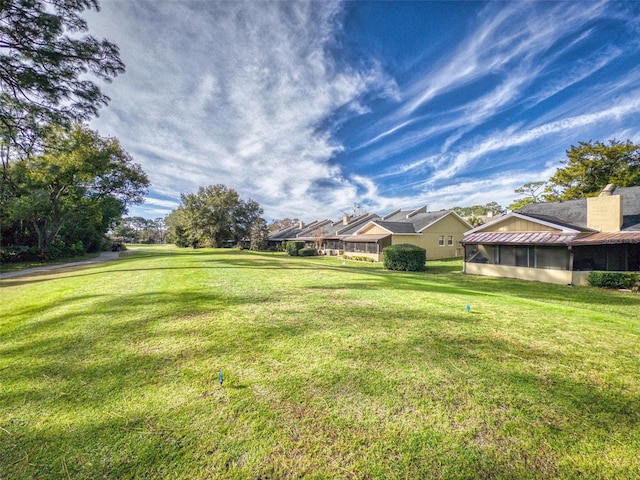 view of yard featuring a sunroom