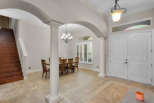 foyer entrance with stairs, ornamental molding, an inviting chandelier, and ornate columns