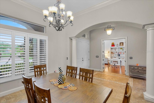 dining area with crown molding, arched walkways, a healthy amount of sunlight, and decorative columns