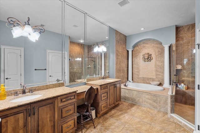 bathroom with ornate columns, a shower stall, visible vents, and vanity