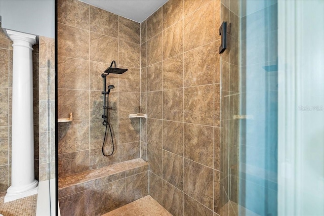 full bath featuring a tile shower and ornate columns