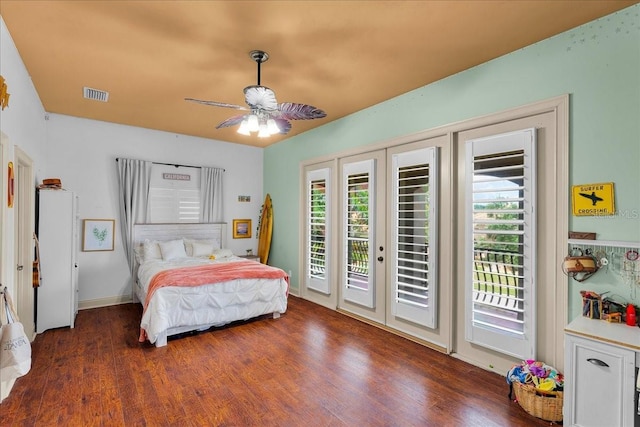 bedroom with access to outside, visible vents, multiple windows, and wood finished floors