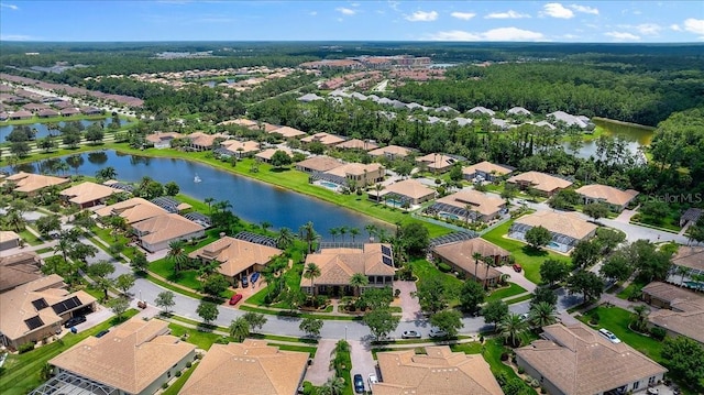 drone / aerial view featuring a residential view and a water view