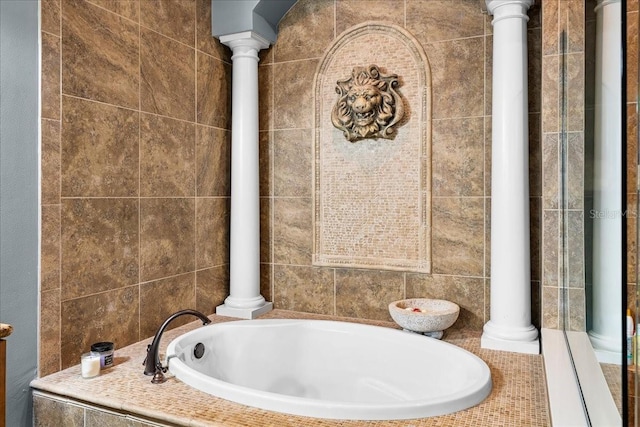 full bath with ornate columns and a bath