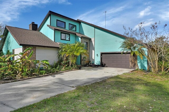 view of front facade with a garage and a front lawn