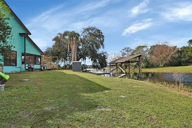 view of yard with a water view and a sunroom