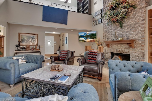 living room featuring built in features and a brick fireplace